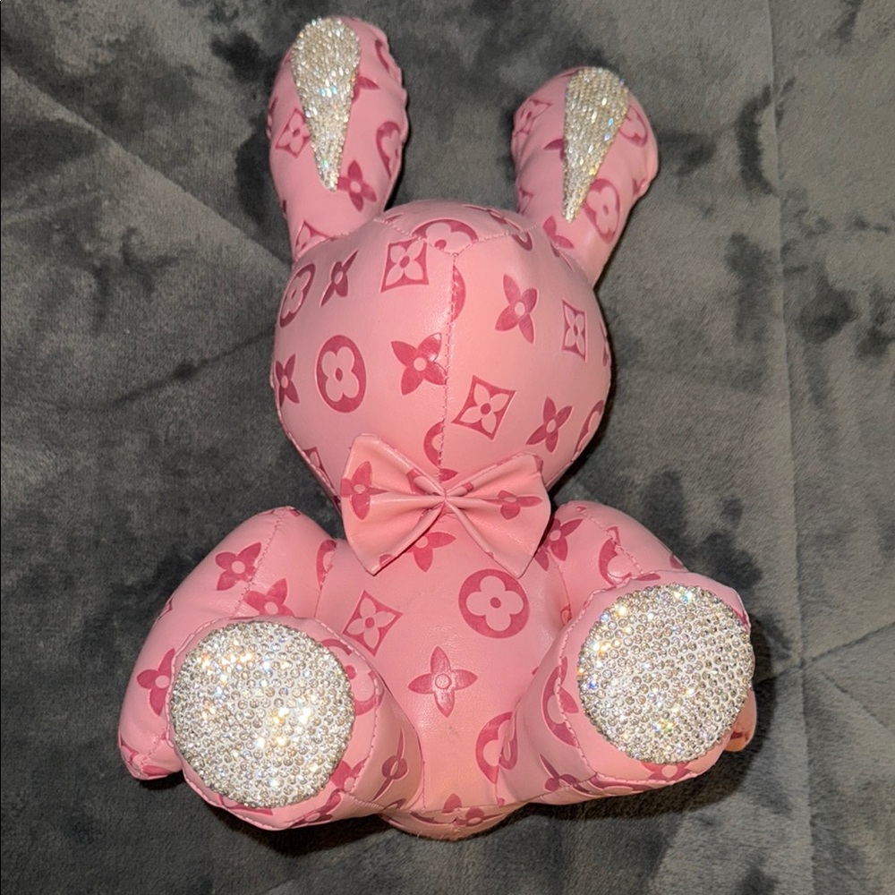 Bunny rabbit made from plush material with leather or canvas accents pink color